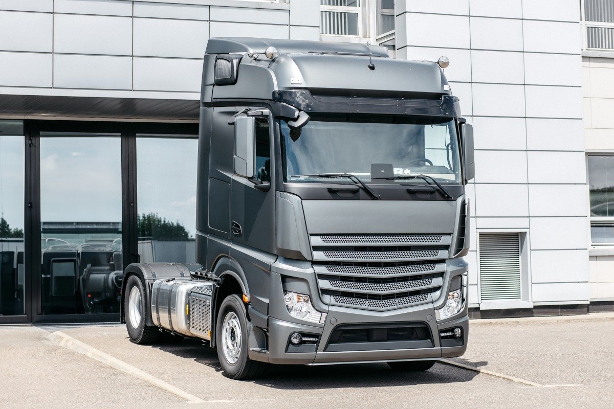 New Semi Truck Tractor For Sale Staying in Line on Dealership Parking Lot. Transportation Industry Business Theme