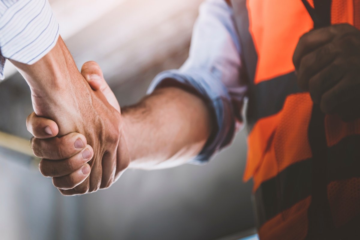 Two engineer shaking hands with deals and congratulations on success, panorama image use for cover design.