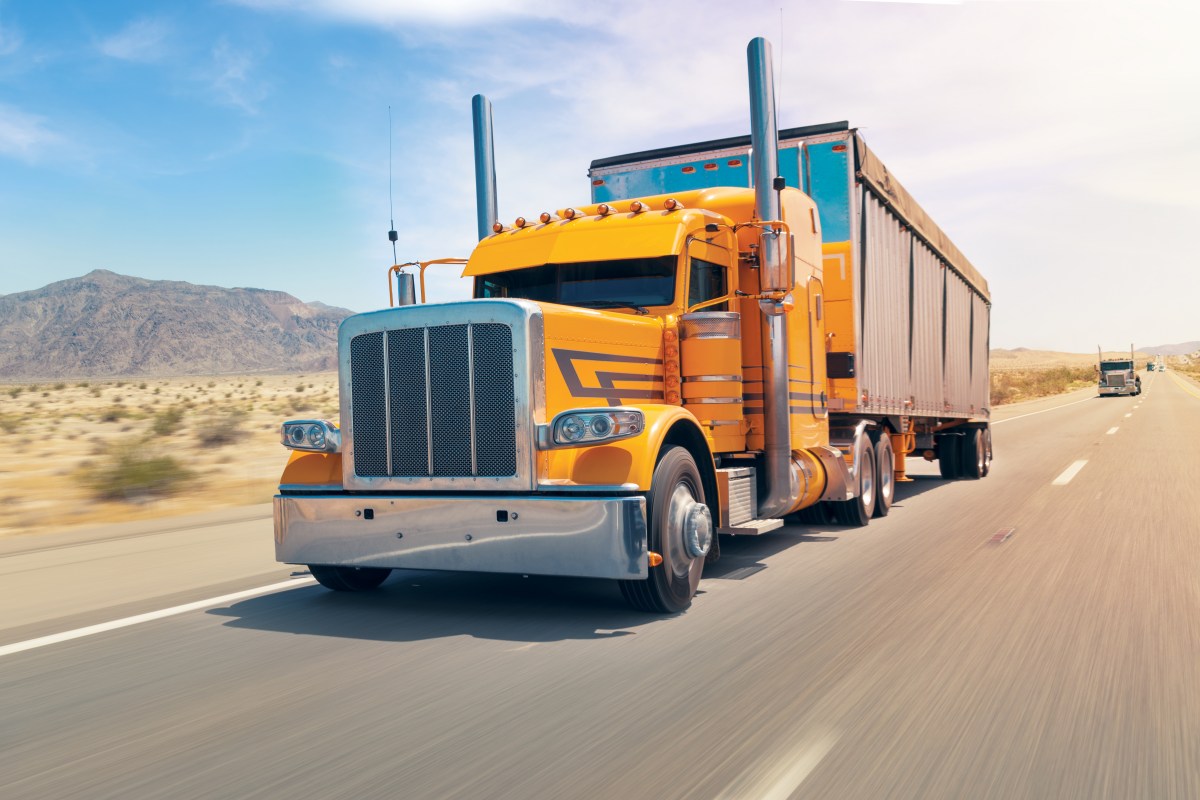 big american orange truck on the speed way