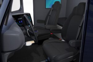 Autonomous truck interior with black seats and wall mounted monitor, full size bed. 3D rendering image.