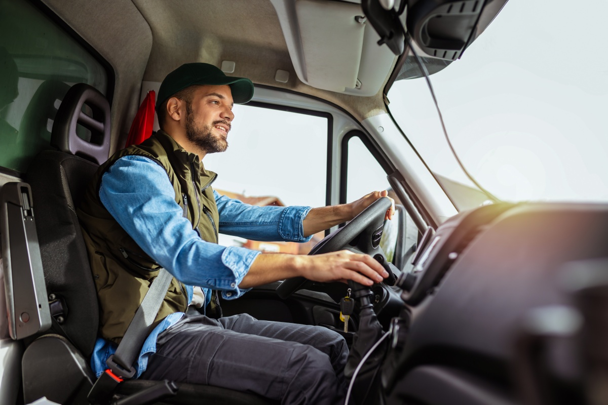 Young man working in towing service and driving his truck.