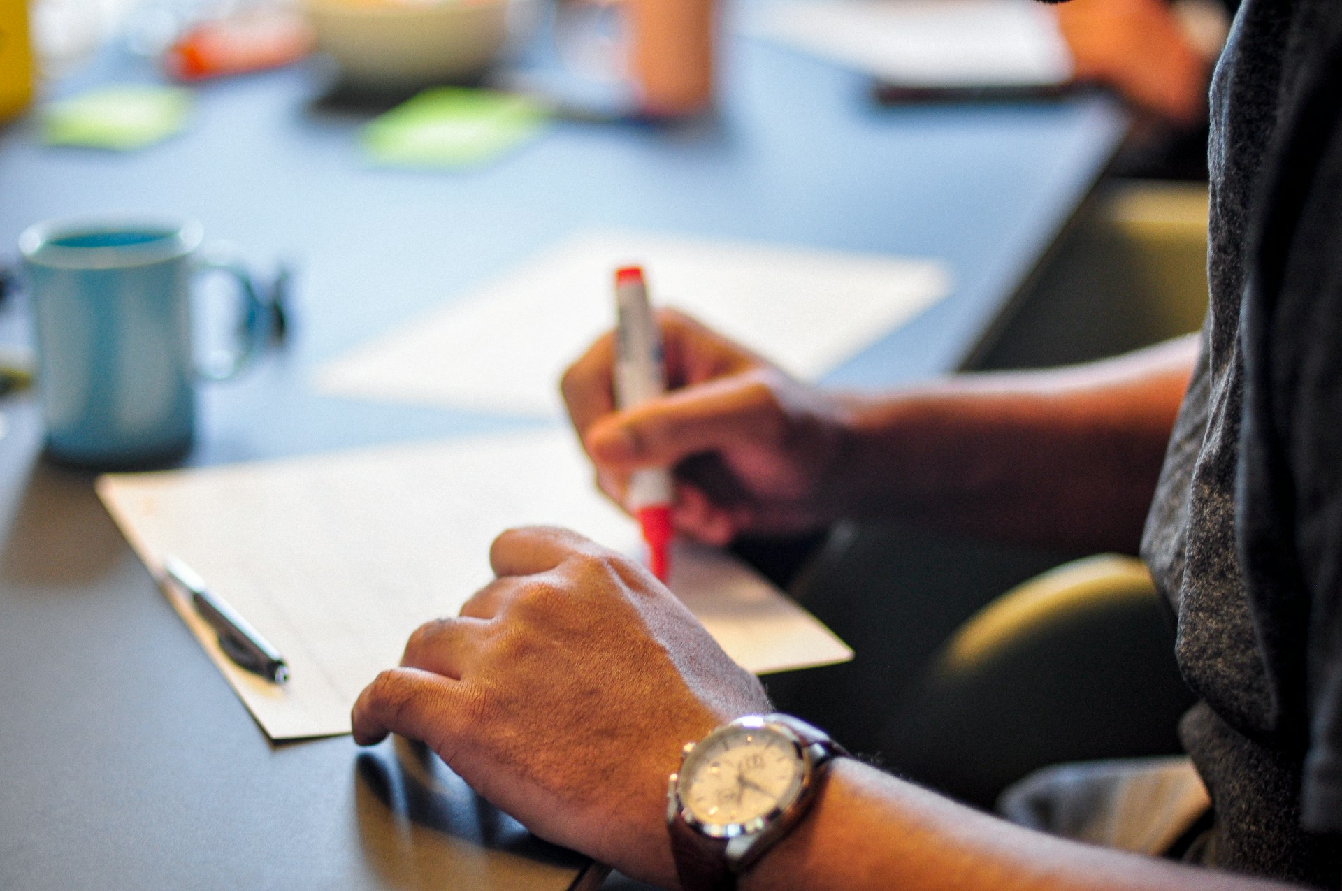 Fleet manager taking notes while reviewing fleet risk management strategies