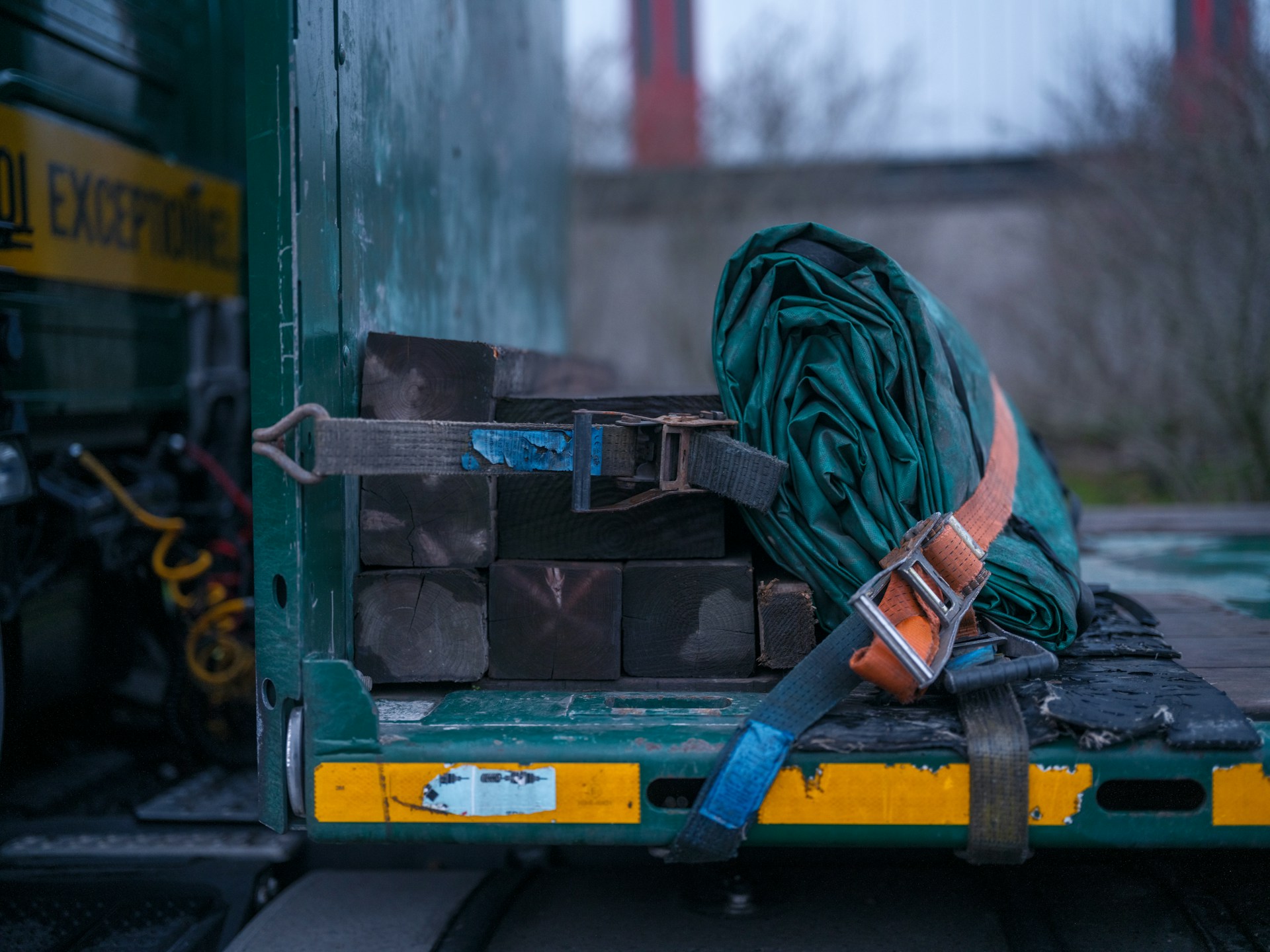 Ratchet straps securing wooden cargo on a commercial truck bed