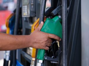 Hand on a fuel or diesel pump at a gas station